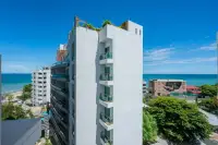 Studio Condo for Sale at Sands Condominium white building exterior with glass balconies rooftop garden and sea view