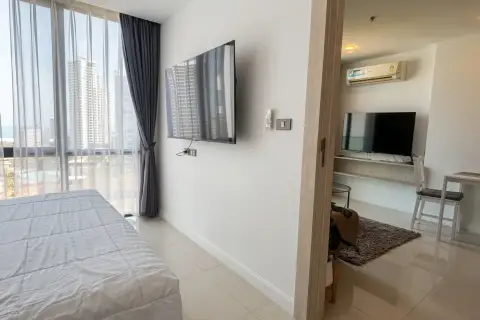 1 Bedroom Condo for Sale at Jewel Pratumnak bedroom view into living area with TV and dining table
