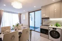 1 Bedroom Condo for Sale at Copacabana Coral Reef dining area and kitchen with crystal chandelier, washing machine and sliding door to private pool