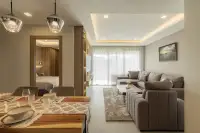 2 Bedroom Condo for Sale at Zensiri Estates and Residences dining area with wood table and pendant lights opening to living room and bedroom