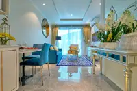 1 Bedroom Condo for Sale at Seven Seas Le Carnival: compact kitchen with sink, microwave, white cabinets, and small dining area.