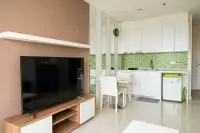1 Bedroom Condo for Sale at Amazon Residence kitchen with white cabinets, green mosaic backsplash, and dining table