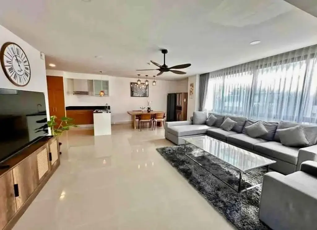 2 Bedroom Condo for Rent at Gardenia Pattaya open-plan living room with gray sectional sofa and ceiling fan