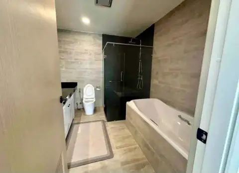 2 Bedroom Condo for Rent at Gardenia Pattaya bathroom with bathtub, glass shower, and toilet