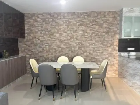 2 Bedroom Condo for Rent at Gardenia Pattaya dining area with marble table and stacked stone feature wall