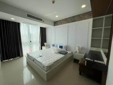 2 Bedroom Condo for Rent at Gardenia Pattaya bedroom with large bed, sheer curtains and city-view window