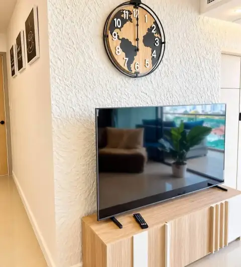 2 Bedroom Condo for Rent at Gardenia Pattaya hallway with wall-mounted TV, world map clock and wooden console