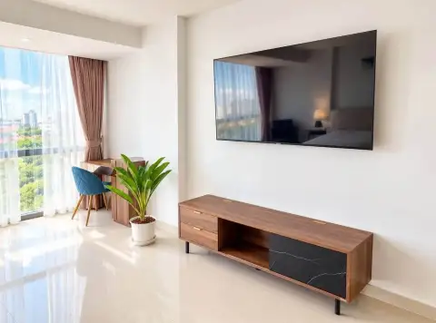 2 Bedroom Condo for Rent at Gardenia Pattaya bedroom with wall-mounted TV, wooden TV console and city view window