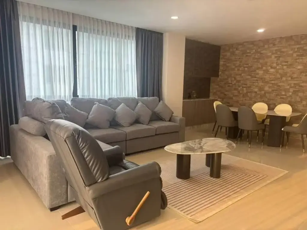 2 Bedroom Condo for Rent at Gardenia Pattaya living room with gray sectional sofa and marble dining table