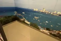 Studio Condo for Sale at Grand Solaire Noble private balcony with sweeping aerial view of Pattaya Bay and boats on turquoise water