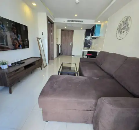 1 Bedroom Condo for Rent at Grand Avenue Residence sectional sofa facing TV with hallway to kitchen and entrance