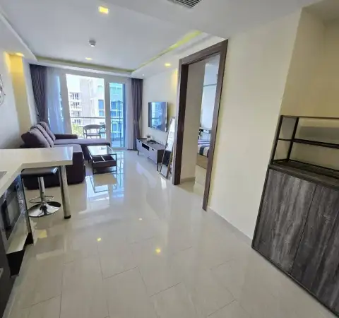 1 Bedroom Condo for Rent at Grand Avenue Residence open living area with tiled flooring leading to bedroom and kitchen