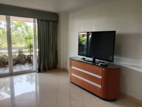 3 Bedroom Condo for Sale at Grand Condotel bedroom corner with flat-screen TV and wooden dresser