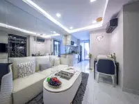 1 Bedroom Condo for Sale at Grand Solaire Noble living room with mirrored wall, dining area, and ocean view