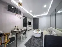 1 Bedroom Condo for Sale at Grand Solaire Noble infinity pool with loungers, palm trees, and sunset sky