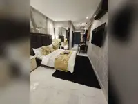 Studio Condo for Sale at Grand Solaire Noble bedroom with sea view window and open kitchen