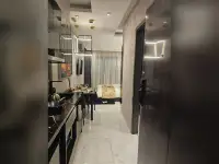 Studio Condo for Sale at Grand Solaire Noble infinity pool deck with palm trees at sunset