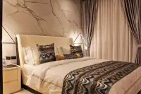 2 Bedroom Condo for Sale at Grand Solaire Pattaya bedroom with patterned throw blanket and marble feature wall