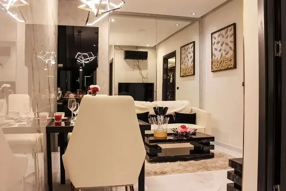 2 Bedroom Condo for Sale at Grand Solaire Pattaya living room with marble walls, dining table and cream sofa