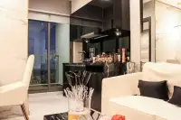 2 Bedroom Condo for Sale at Grand Solaire Pattaya open kitchen with black marble counter and city view balcony
