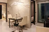 2 Bedroom Condo for Sale at Grand Solaire Pattaya dining area with marble accent wall and geometric pendant light