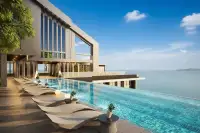 2 Bedroom Condo for Sale at Grand Solaire Pattaya rooftop infinity pool with lounge chairs and ocean view