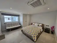 3 Bedroom Condo for Sale at Grand View Condo bright bedroom with sofa bed and large window