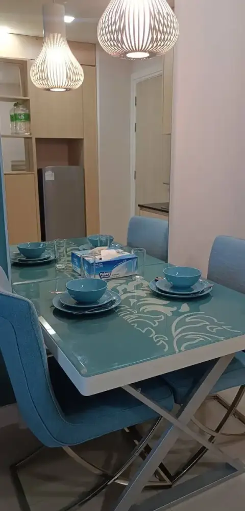 1 Bedroom Condo for Rent at Grande Caribbean dining table set with blue bowls and pendant lighting