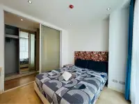 2 Bedroom Condo for Sale at Grande Caribbean bedroom with mirrored closet and floral headboard