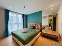 2 Bedroom Condo for Sale at Grande Caribbean master bedroom with teal accent wall and green bedding