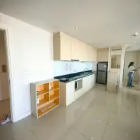 2 Bedroom Condo for Sale at Grande Caribbean open kitchen with wood cabinets and stainless fridge