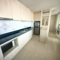 2 Bedroom Condo for Sale at Grande Caribbean galley kitchen with black countertop and sink