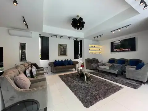 7 Bedroom House for Rent at Green Residence Village spacious living room with velvet sofas, chandelier, and wall-mounted TV