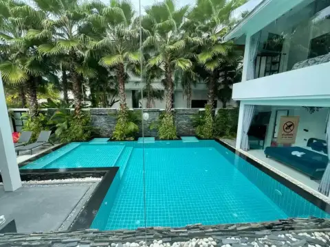 7 Bedroom House for Rent at Green Residence Village tiled swimming pool with sun loungers surrounded by palm trees