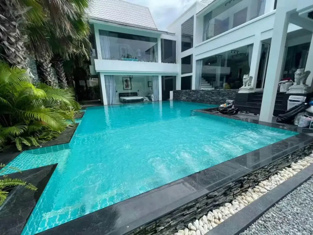 7 Bedroom House for Rent at Green Residence Village modern two-story home with large turquoise swimming pool and tropical palm landscaping