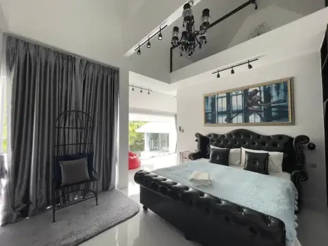 7 Bedroom House for Rent at Green Residence Village elegant bedroom with tufted black leather bed and chandelier
