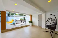 5 Bedroom House for Sale in Bang Lamung, covered patio with swing bench, hanging chair, and pool view.