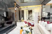 5 Bedroom House for Sale at Harmony Hills Villas Pattaya elegant living room with marble accents, high ceilings, and staircase.