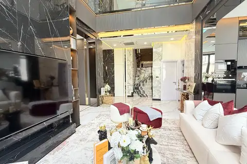 5 Bedroom House for Sale at Harmony Hills Villas Pattaya elegant living room with marble accents, high ceilings, and staircase.