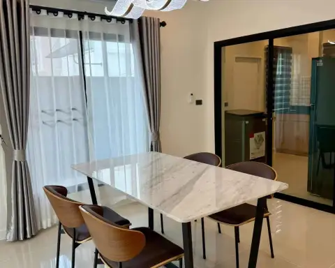 3 Bedroom House for Rent at H Living Life Chaipornwithi dining space with sheer curtains and sliding glass door