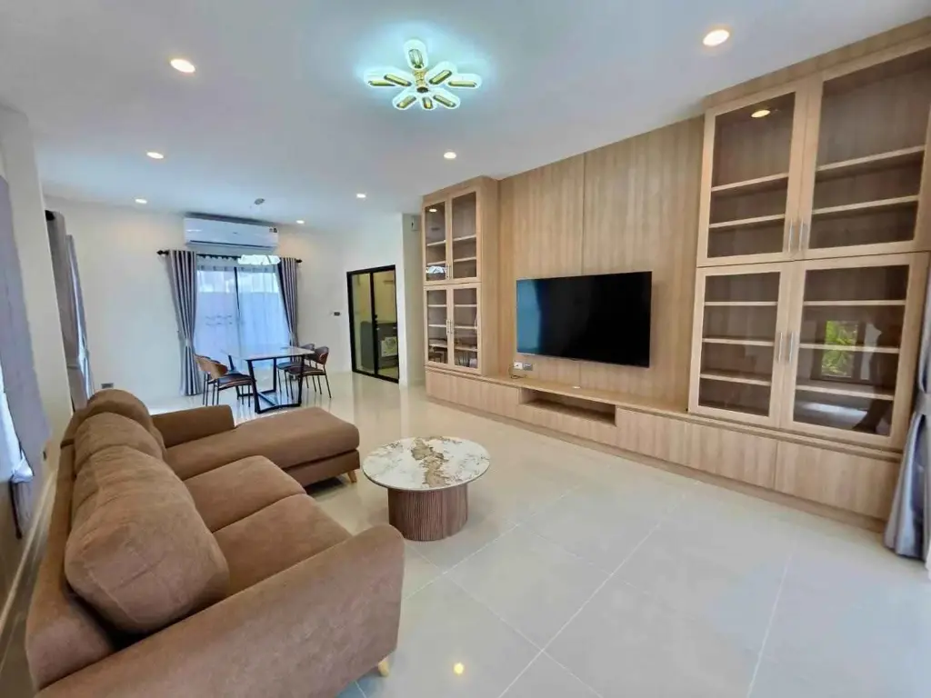 3 Bedroom House for Rent at H Living Life Chaipornwithi living room with wooden TV cabinet and brown sofa