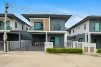 3 Bedroom House for Sale at Patta Define two-story exterior with carport and gated entrance