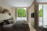 1 Bedroom Condo for Sale at Harmonia City Garden bedroom with gray bedding, wall-mounted TV and sliding door to poolside balcony