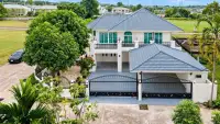 4 Bedroom House for Sale at Hill View Villas aerial view of two-story home with blue tiled roof and gated driveway