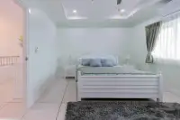 4 Bedroom House for Sale at Hill View Villas mint green bedroom with white bed frame and plush rug