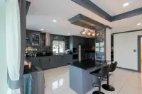 4 Bedroom House for Sale at Hill View Villas open kitchen with island, bar stools, and pendant lighting