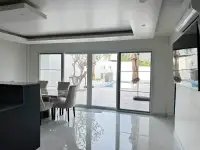 3 Bedroom House for Sale at Hillside Village Pattaya open-plan dining area with sliding glass doors to pool patio
