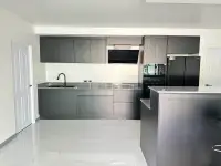 3 Bedroom House for Sale at Hillside Village Pattaya fitted kitchen with black cabinets and built-in appliances