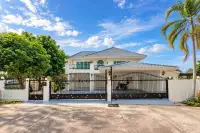 4 Bedroom House for Sale in East Pattaya two-story exterior with gated entrance and palm trees