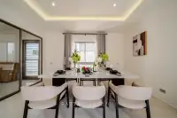 4 Bedroom House for Sale at Horizon By Patta elegant dining room with marble table, upholstered chairs and cove ceiling